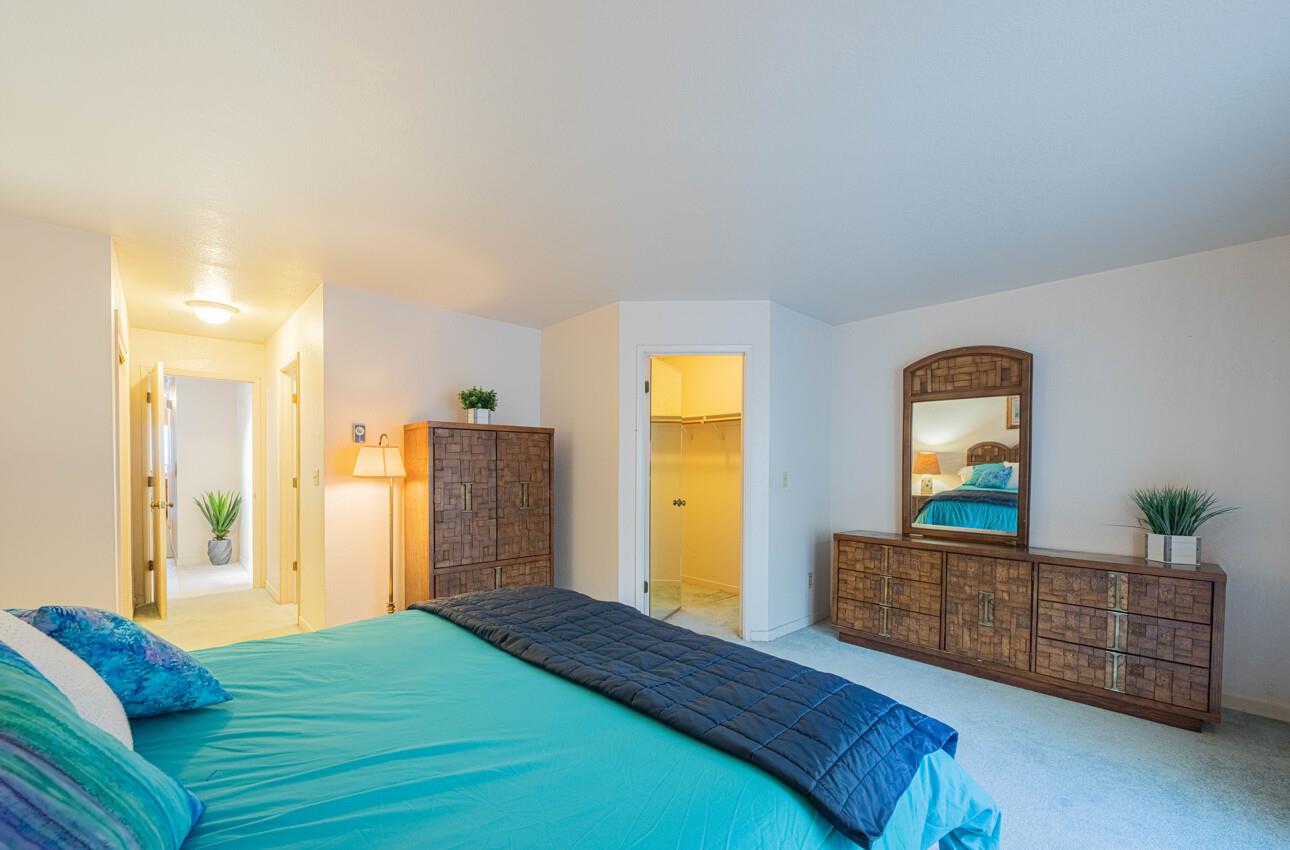 585 Hawthorne Street, Unit 103 Monterey, CA 93940 - Photo 18 of 30 a bedroom with a bed and wooden floor