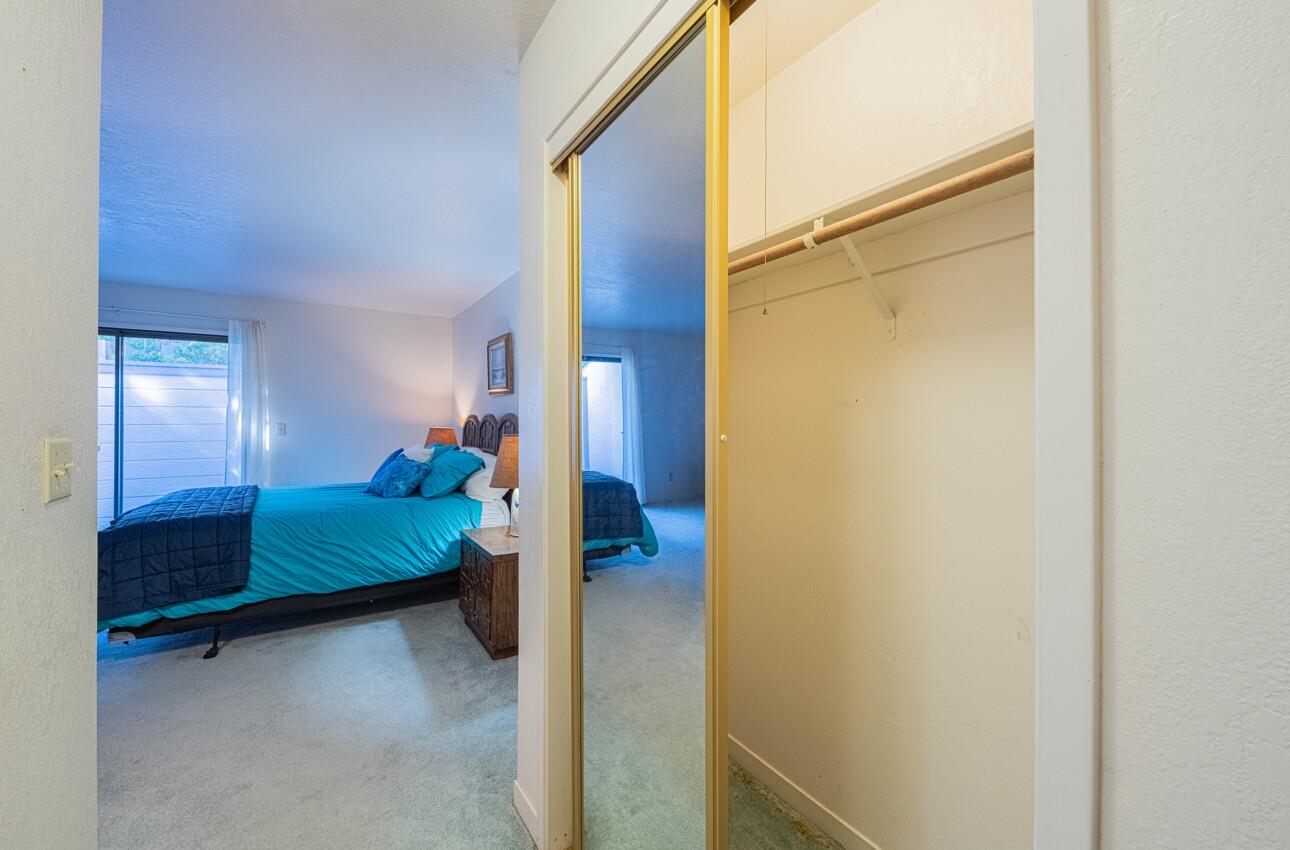 585 Hawthorne Street, Unit 103 Monterey, CA 93940 - Photo 20 of 30 a bedroom with a bed and a cabinets