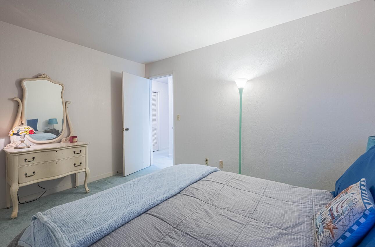 585 Hawthorne Street, Unit 103 Monterey, CA 93940 - Photo 27 of 30 a bedroom with a bed and a dresser
