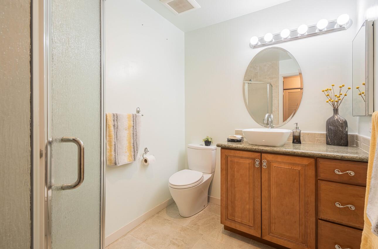 585 Hawthorne Street, Unit 103 Monterey, CA 93940 - Photo 28 of 30 a bathroom with a toilet sink and mirror