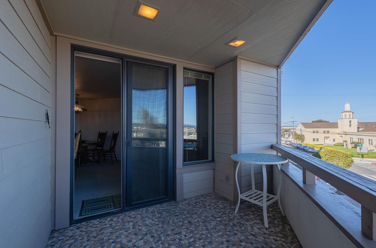 585 Hawthorne Street, Unit 103 Monterey, CA 93940 - Photo 9 of 30 a balcony with a table and chairs