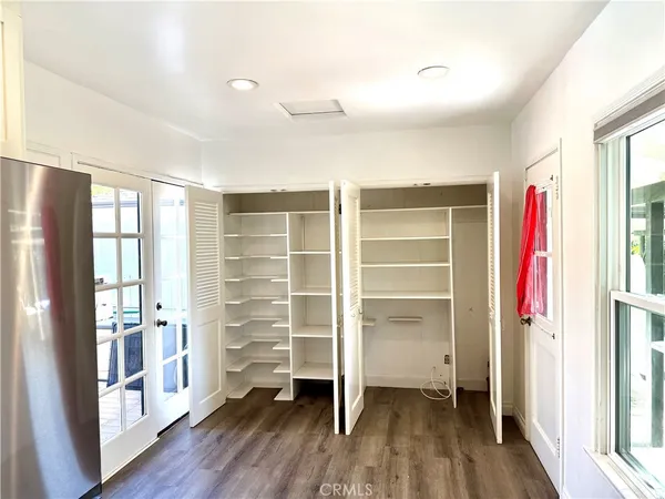 a view of walk in closet with empty racks