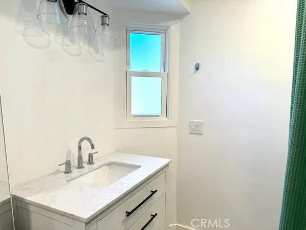 a close up of a sink and a mirror