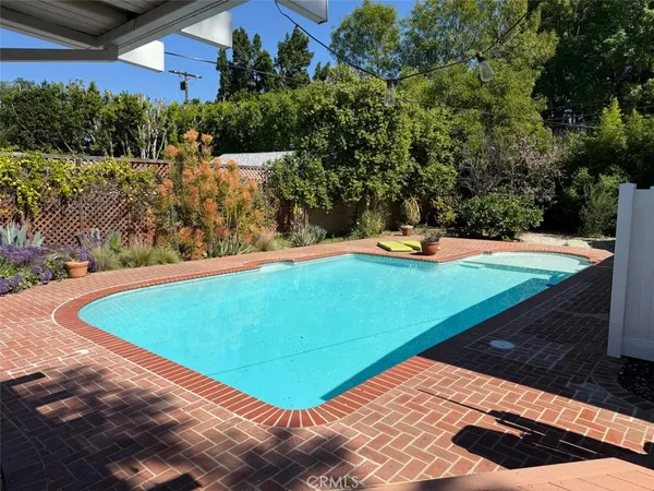 a view of a pool with a yard