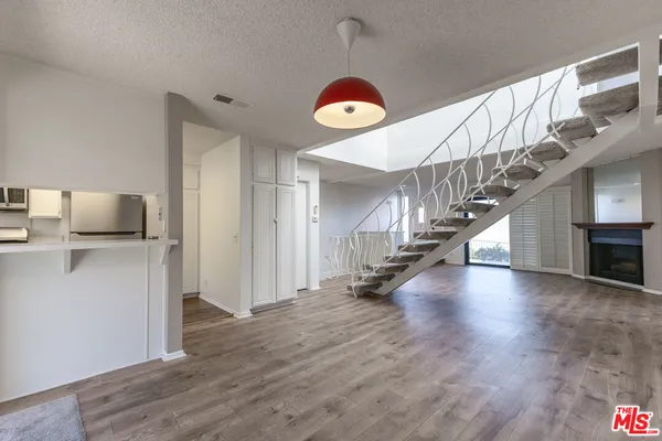 a view of entryway and hall with wooden floor