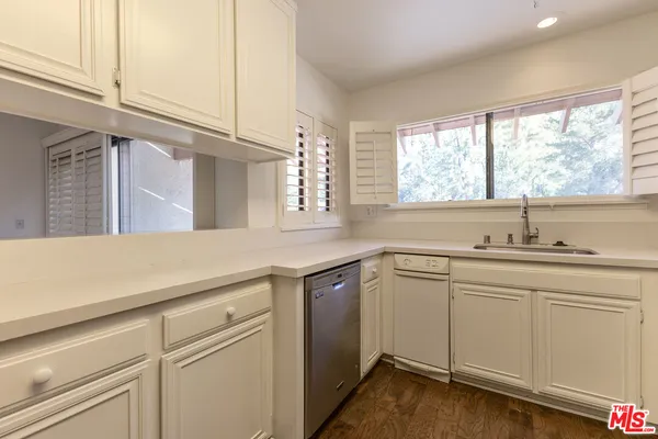 a kitchen with a sink cabinets and window