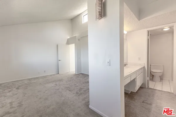 a view of an empty room and bathroom