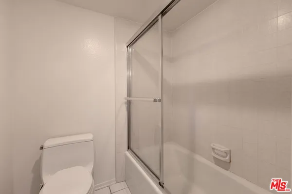 a bathroom with a toilet and a bathtub