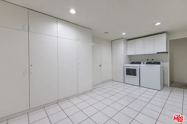 a kitchen with cabinets and white appliances