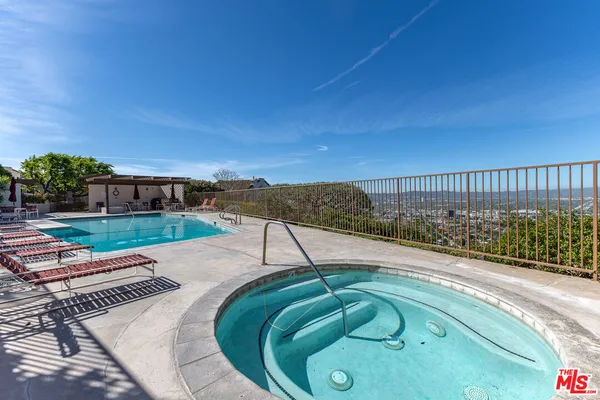 a backyard of a house with lots of green space and outdoor seating