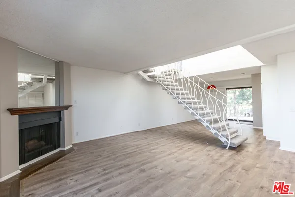 a view of entryway and hall with a fireplace