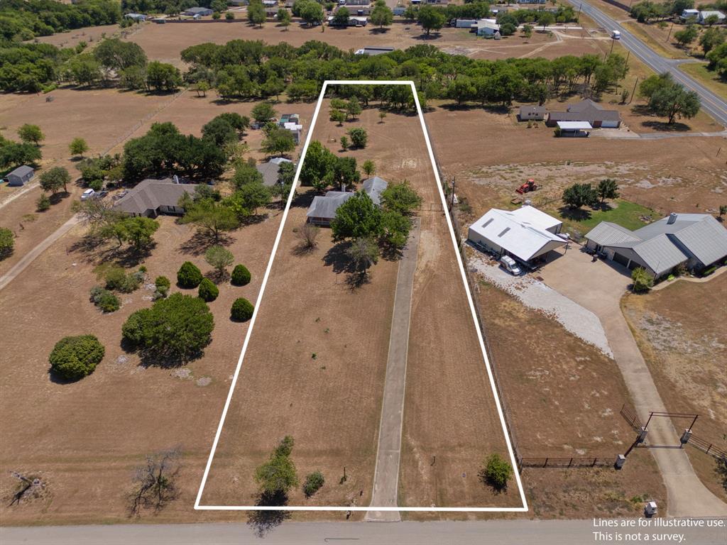 162 Warren Road Lorena, TX 76655 - Photo 35 of 39 Expansive land parcel featuring a paved driveway, mature trees, and natural landscaping