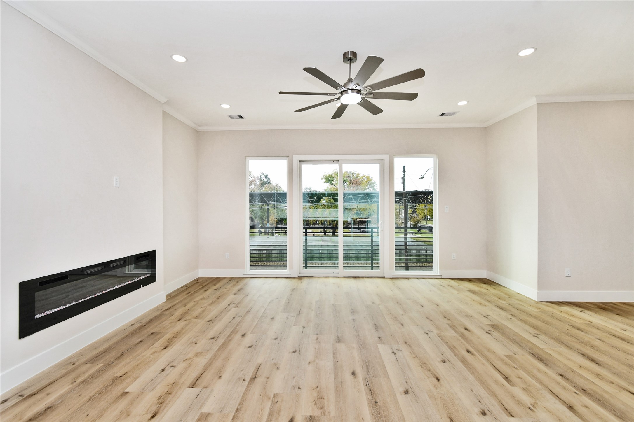 3229 Tuam Street Houston, TX 77004 - Photo 13 of 50 2nd floor-Living area with modern fireplace and park view