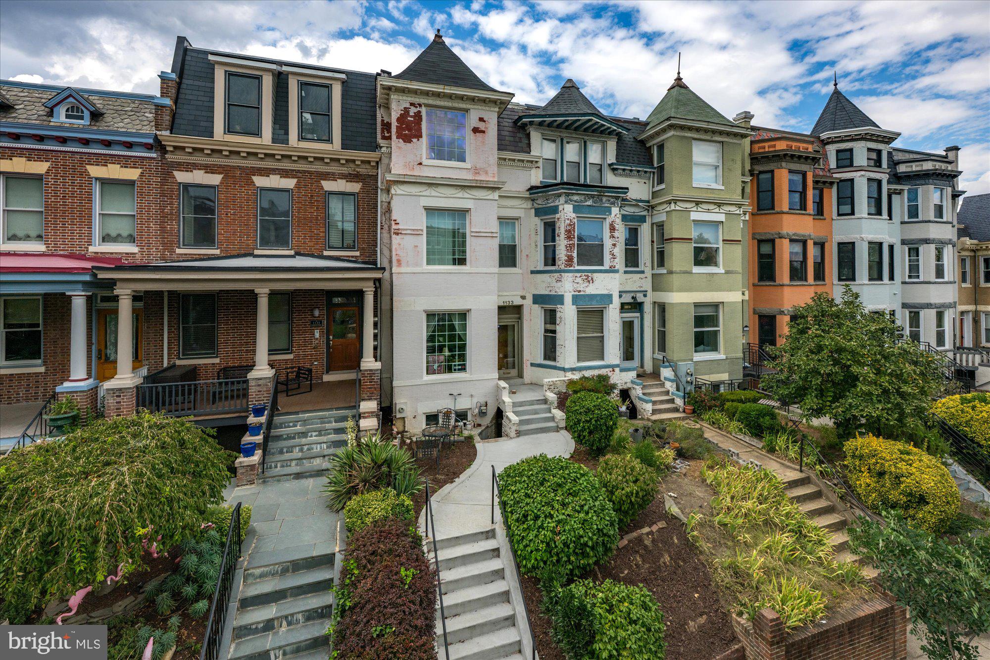 1133 Fairmont Street Northwest Washington, DC 20009 - Photo 1 of 1 a front view of a residential apartment building with a yard