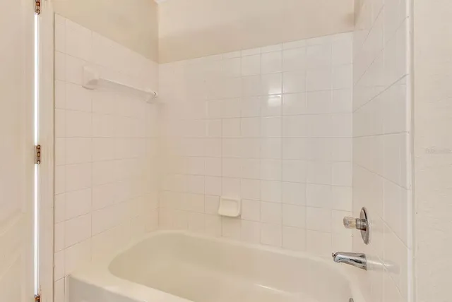a kitchen with granite countertop a stove top oven and cabinets