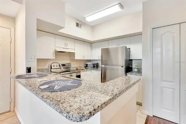 a view of a big room with wooden floor and windows