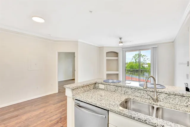 a bathroom with a granite countertop sink a toilet and a mirror