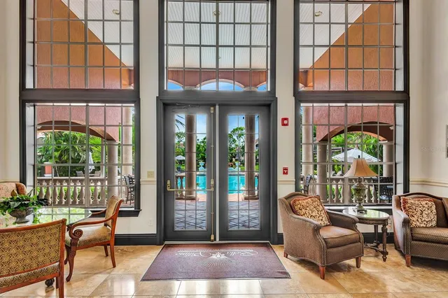 a view of a room with a sink and chandelier fan