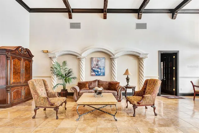 a view of a room with wooden floor table and chairs