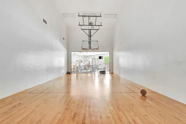 a front view of a house with a yard and palm trees