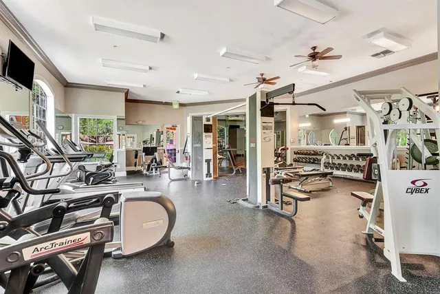 a front view of a house with a yard and a fountain
