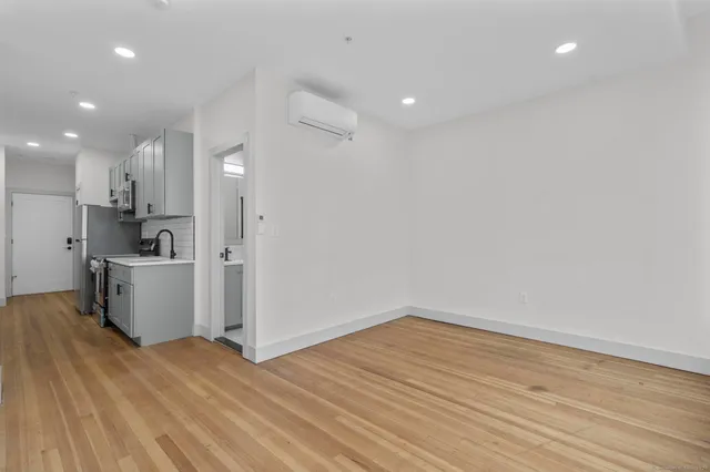 a view of a kitchen with wooden floor