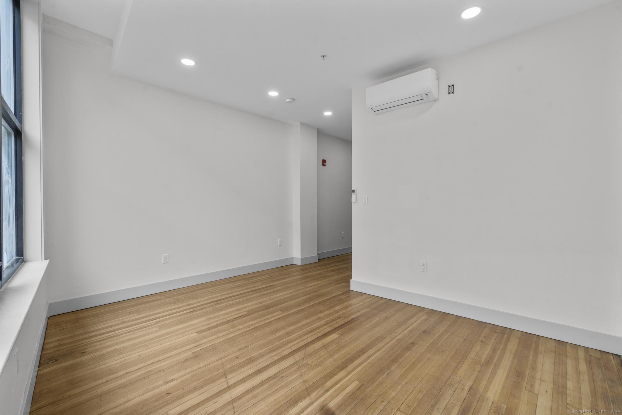 111 Bank Street, Unit 2A Waterbury, CT 06702 - Photo 6 of 16 a view of an empty room with wooden floor