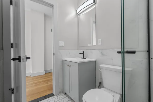 a bathroom with a sink toilet and shower