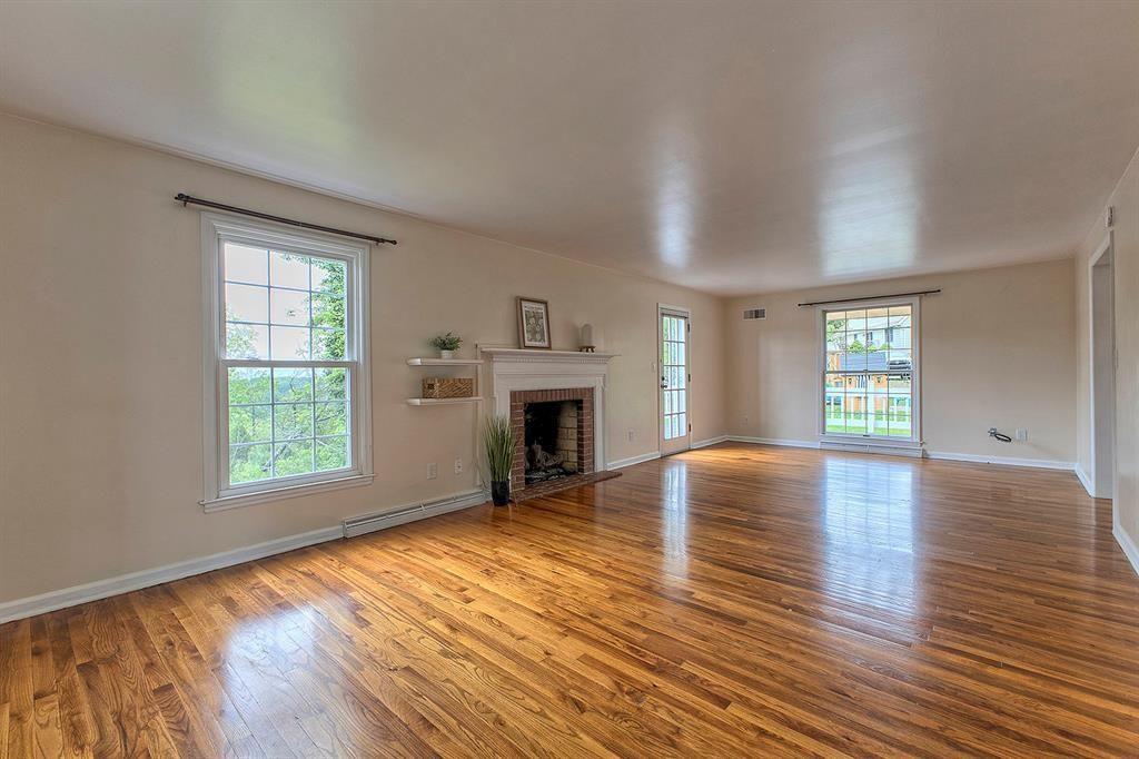 3222 Ridgeway Road Greensburg, PA 15601 - Photo 16 of 46 an empty room with wooden floor fireplace and windows
