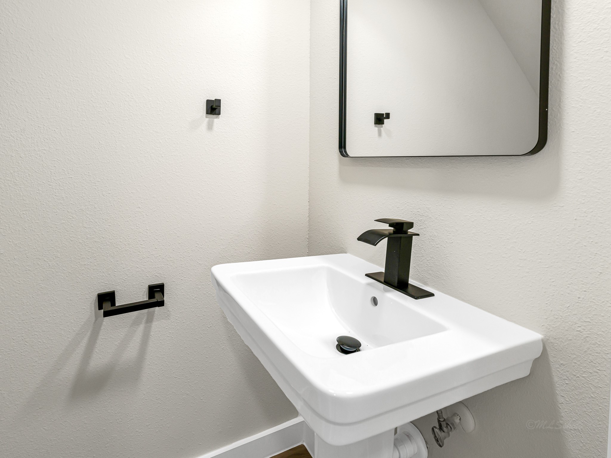 1006 4th Street Hempstead, TX 77445 - Photo 13 of 29 a bathroom with a sink and mirror