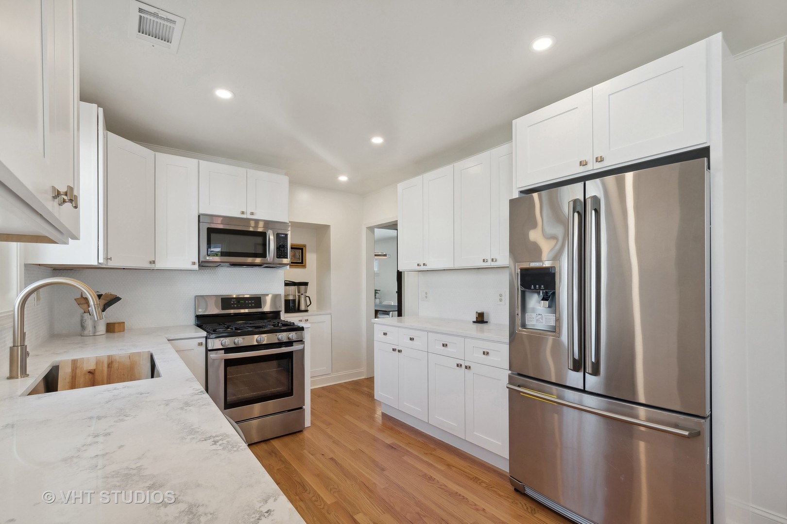 116 High Street Highwood, IL 60040 - Photo 6 of 18 a kitchen with stainless steel appliances a refrigerator stove microwave and sink