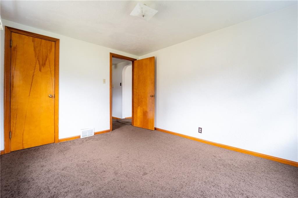 1590 New Stanton Ruffsdale Road Ruffs Dale, PA 15679 - Photo 6 of 16 a view of an empty room with wooden floor and a window