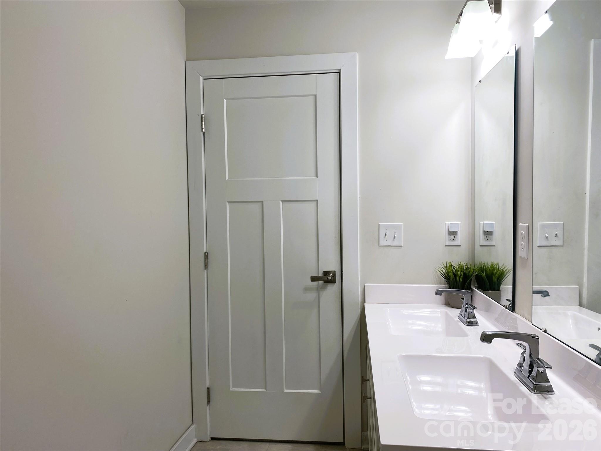 3163 Streamside Drive Davidson, NC 28036 - Photo 11 of 20 a bathroom with a sink and a mirror