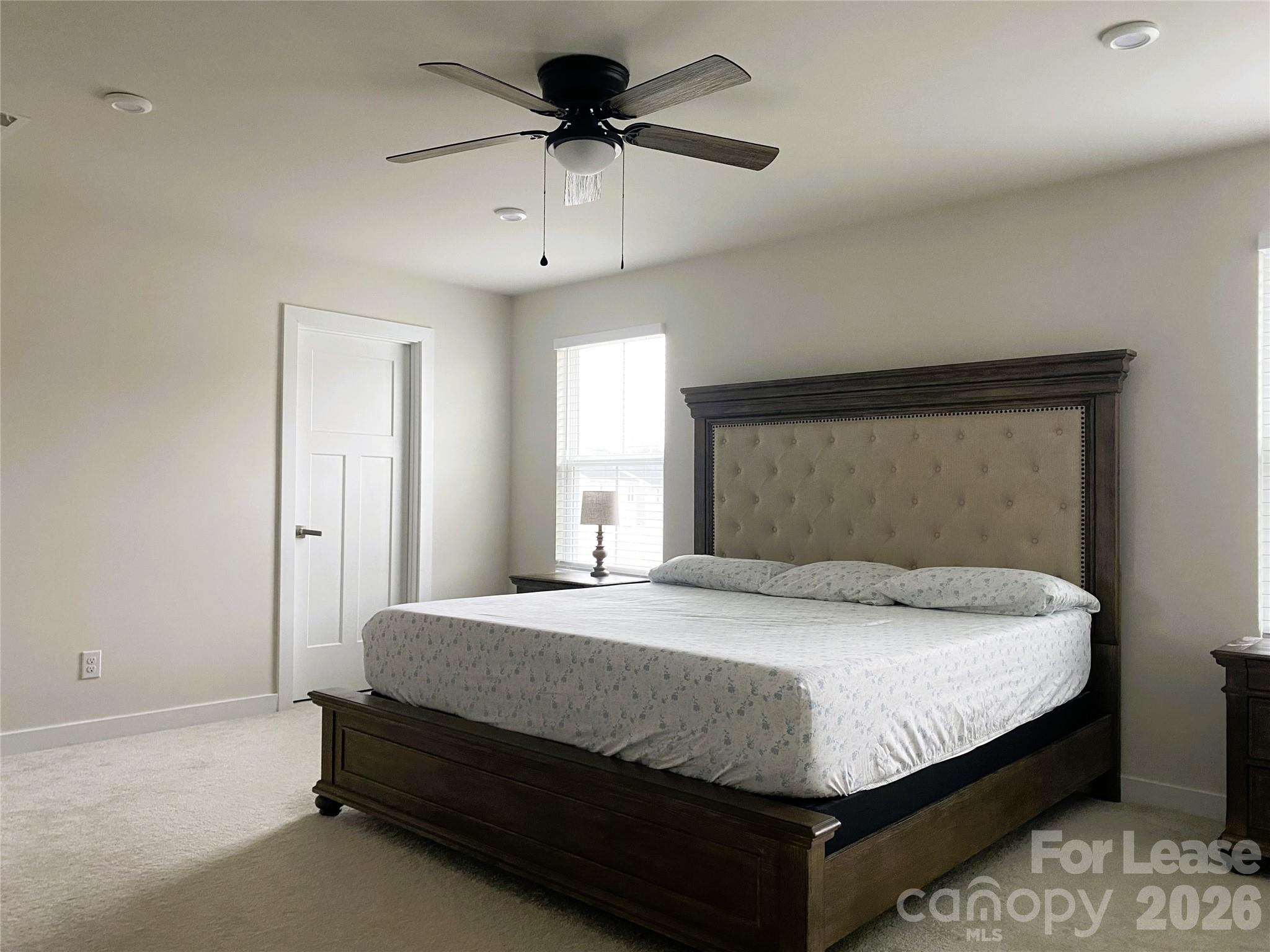 3163 Streamside Drive Davidson, NC 28036 - Photo 12 of 20 a bedroom with a bed and a chandelier