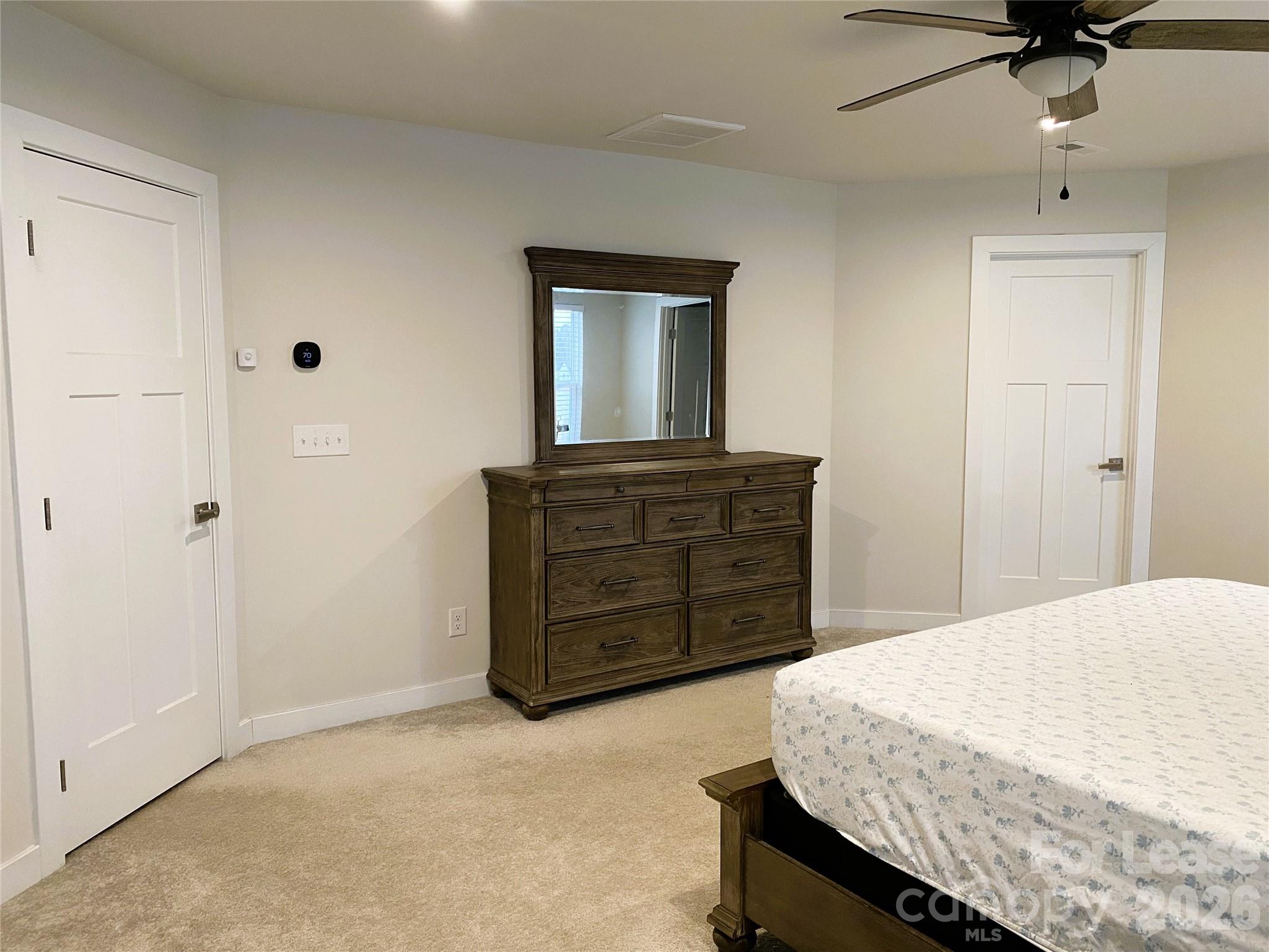 3163 Streamside Drive Davidson, NC 28036 - Photo 14 of 20 a bedroom with a bed and a dresser