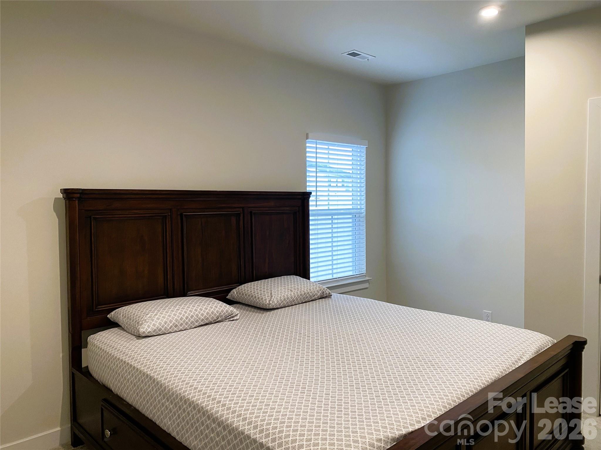 3163 Streamside Drive Davidson, NC 28036 - Photo 9 of 20 a bedroom with a bed and a window