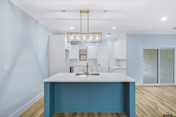 a view of a kitchen sink and chandelier