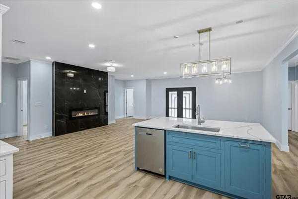 a spacious bathroom with a granite countertop sink a mirror and shower