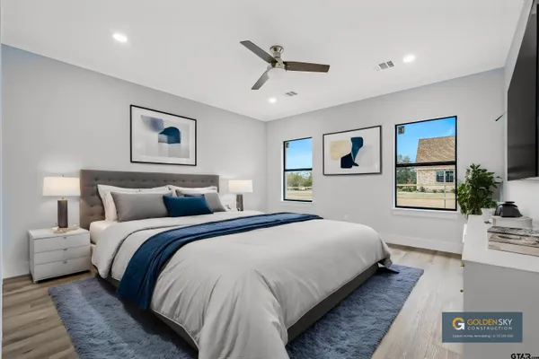 a spacious bedroom with a bed and a large window