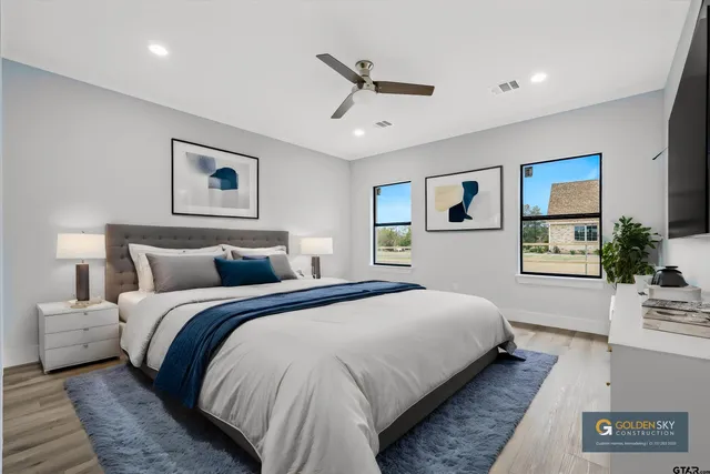 a spacious bedroom with a bed and a large window