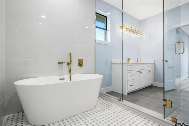 a white bath tub sitting next to a bathroom