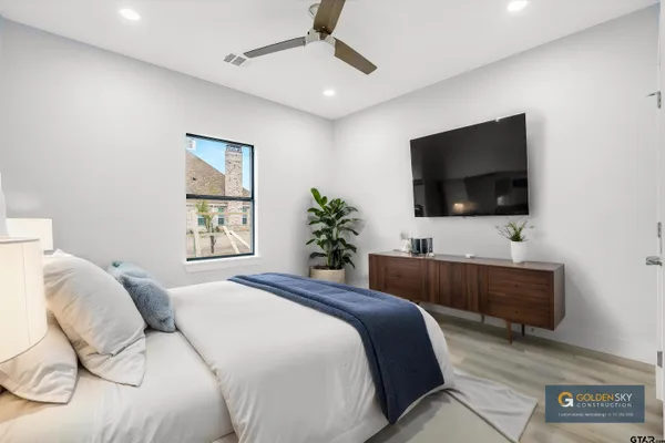 a bedroom with a bed and a flat screen tv