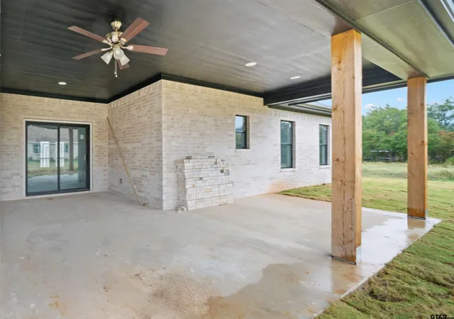 a view of a livingroom with a ceiling fan and window