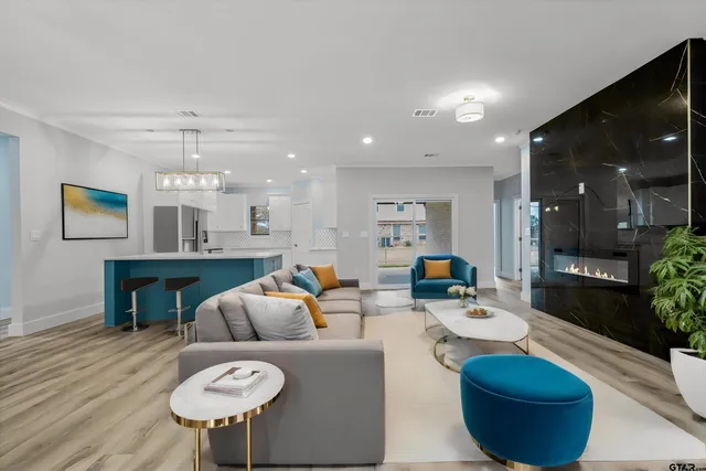 a living room with furniture a lamp and a potted plant