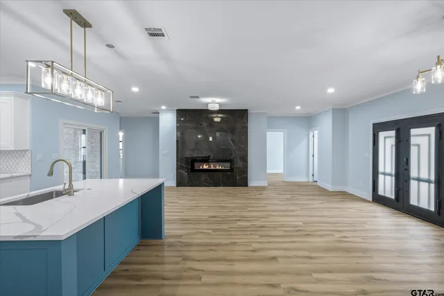 a large kitchen with kitchen island a sink stainless steel appliances and window