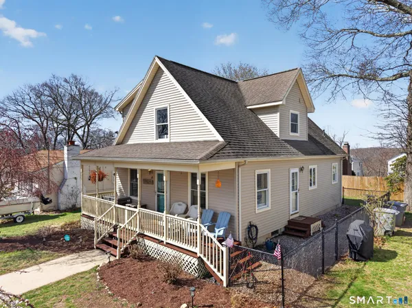 a view of house and a yard with furniture