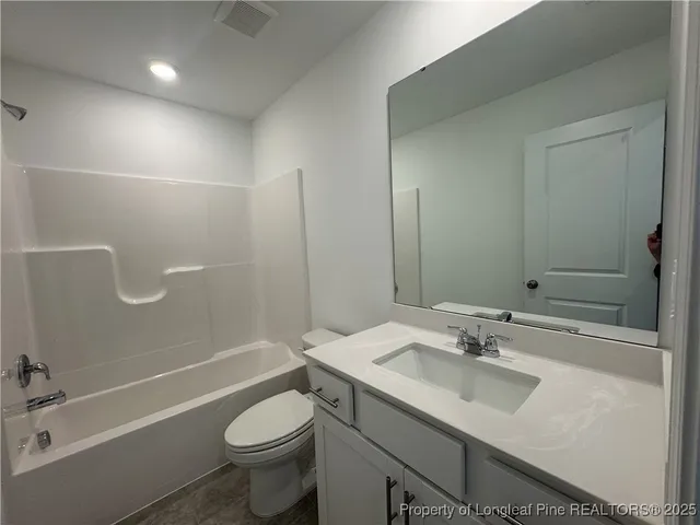 a bathroom with a sink toilet mirror and shower