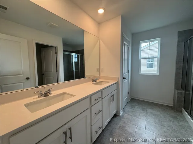 a spacious bathroom with a double vanity sink mirror and double
