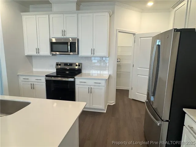 a kitchen with stainless steel appliances a refrigerator stove and sink