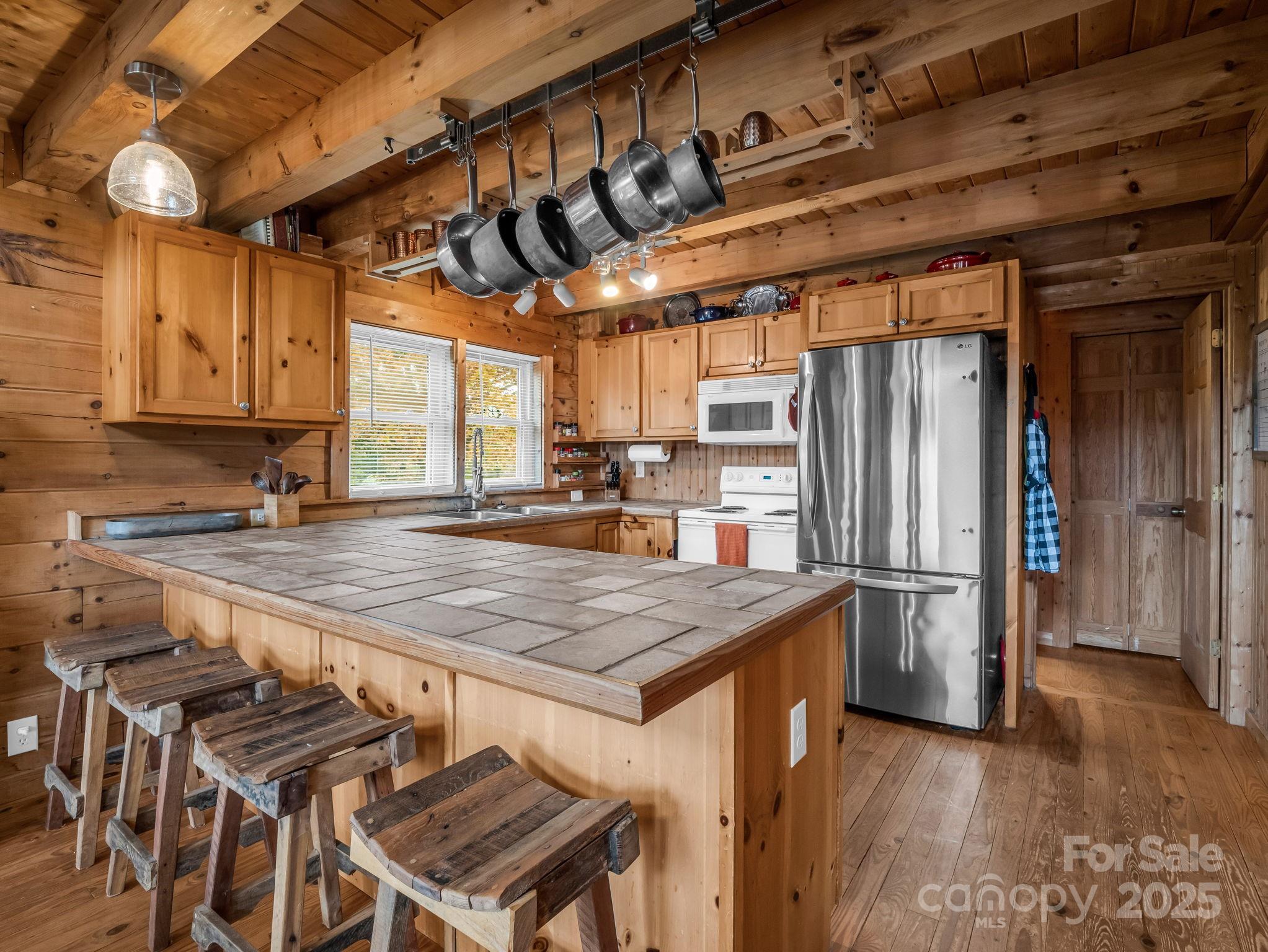 557 Emerald Parkway Rutherfordton, NC 28139 - Photo 15 of 48 a kitchen with stainless steel appliances granite countertop a table chairs and a refrigerator